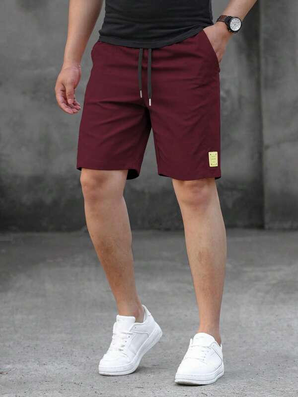 Loose fit men's shorts, monogram patch, drawstring waist Loose fit men's shorts, monogram patch, drawstring waist
